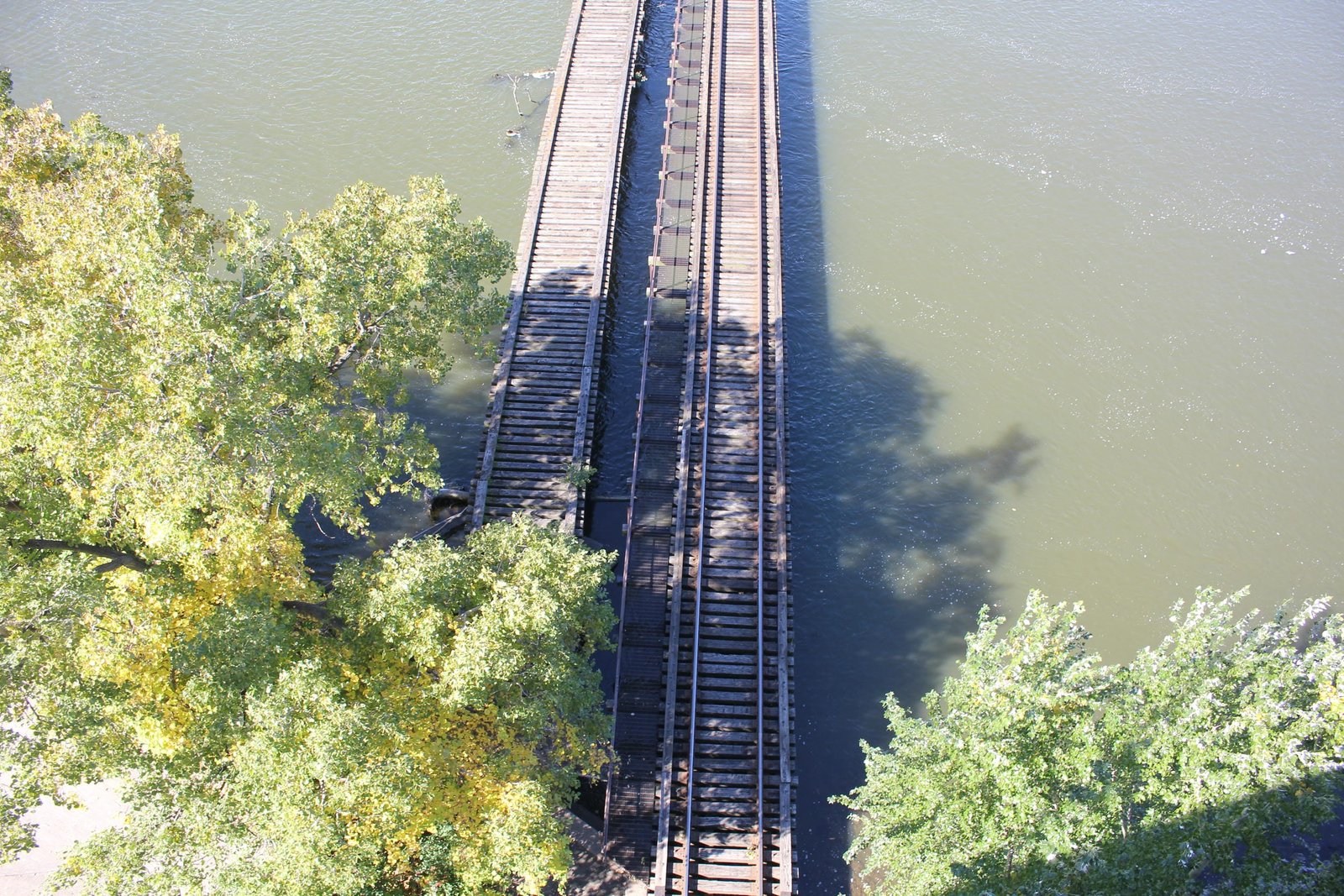 Deck view from Oneida Street Bridge.  Milwaukee Road bridge on left, C&NW bridge on right.